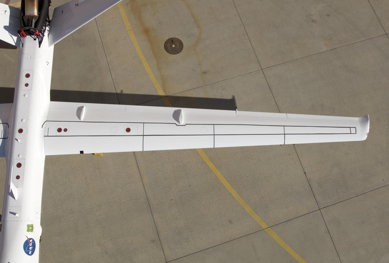 Although the new fiber optic sensors on the Ikhana, which are located on fibers that are the diameter of a human hair, are not visible, the sealant used to cover them can be seen in this view from above the left wing. NASA Dryden Flight Research Center is evaluating an advanced fiber optic-based sensing technology installed on the wings of NASA's Ikhana aircraft. The fiber optic system measures and displays the shape of the aircraft's wings in flight. There are other potential safety applications for the technology, such as vehicle structural health monitoring. If an aircraft structure can be monitored with sensors and a computer can manipulate flight control surfaces to compensate for stresses on the wings, structural control can be established to prevent situations that might otherwise result in a loss of control.