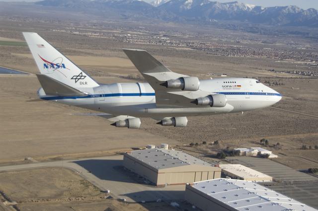 NASA image: NASA's SOFIA infrared observatory 747SP is shadowed by a NASA F-18 during a flyby at its new home, the Dryden Aircraft Operations Facility in Palmdale, Calif