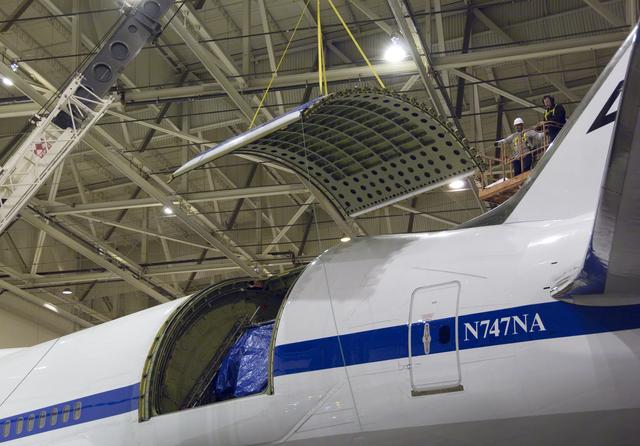 NASA image: Technicians guide removal of the upper rigid door assembly that covers the telescope cavity on NASA's SOFIA 747SP in preparation for primary mirror removal