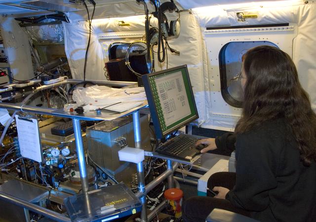 Deedee Montzka of the National Center for Atmospheric Research checks out the NOxyO3 instrument on NASA's DC-8 flying laboratory before the ARCTAS mission