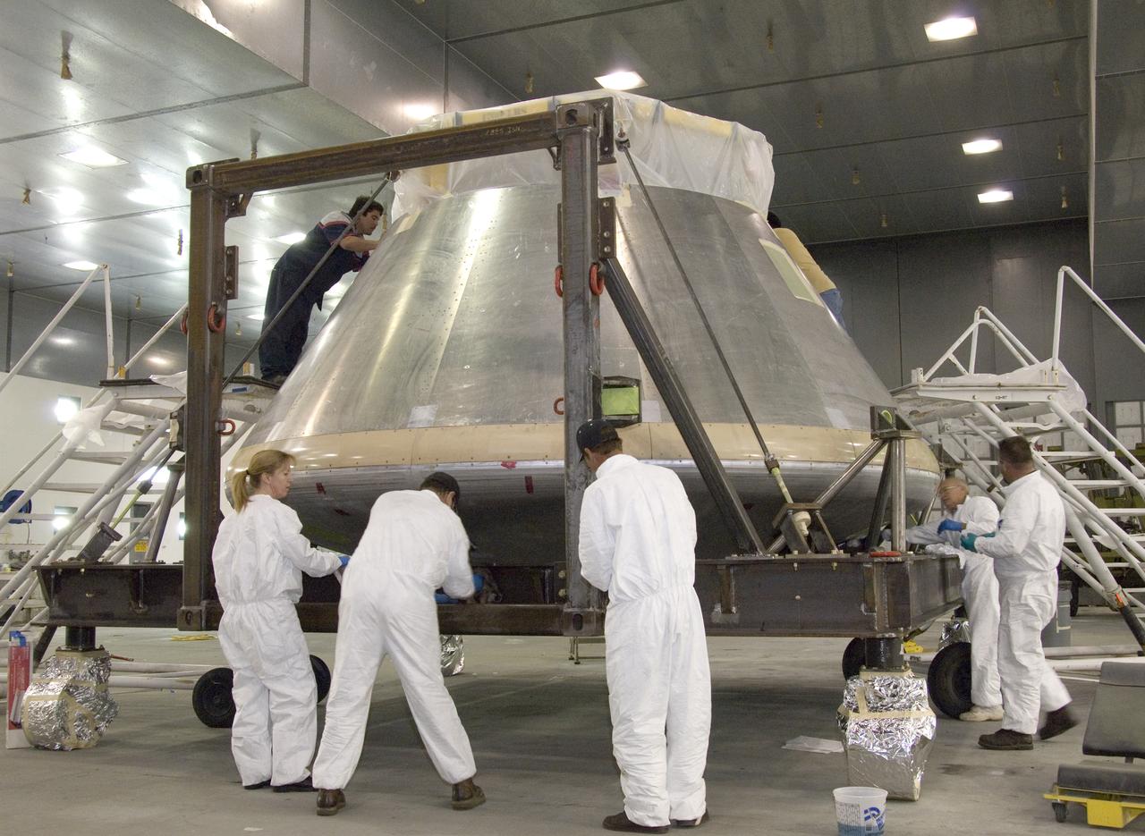 A full-scale flight-test mockup of the Constellation program's Orion crew vehicle arrived at NASA's Dryden Flight Research Center in late March 2008 to undergo preparations for the first short-range flight test of the spacecraft's astronaut escape system later that year. Engineers and technicians at NASA's Langley Research Center fabricated the structure, which precisely represents the size, outer shape and mass characteristics of the Orion space capsule. The Orion crew module mockup was ferried to NASA Dryden on an Air Force C-17. After painting in the Edwards Air Force Base paint hangar, the conical capsule was taken to Dryden for installation of flight computers, instrumentation and other electronics prior to being sent to the U.S. Army's White Sands Missile Range in New Mexico for integration with the escape system and the first abort flight test in late 2008. The tests were designed to ensure a safe, reliable method of escape for astronauts in case of an emergency.