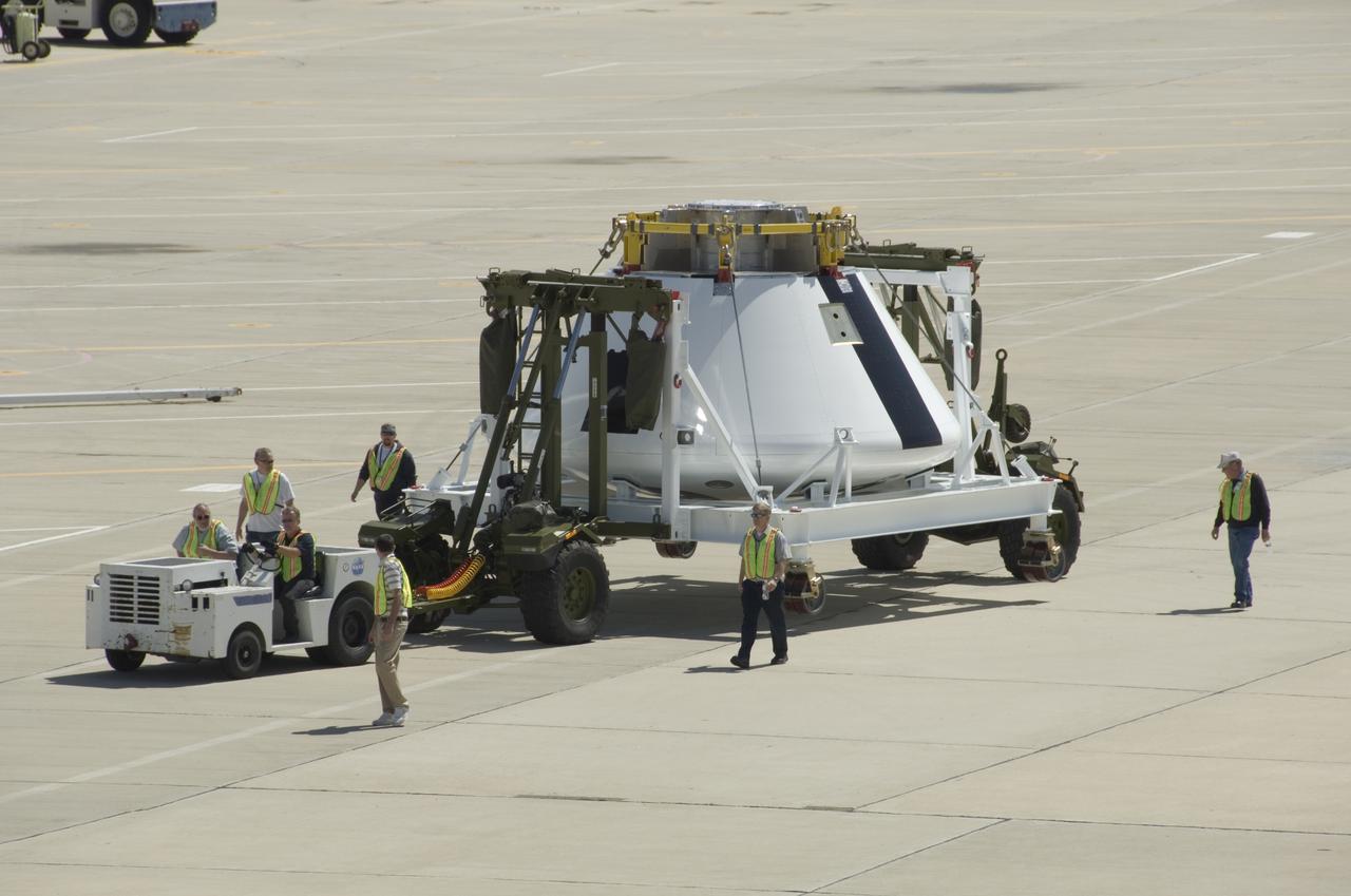 A full-scale flight-test mockup of the Constellation program's Orion crew vehicle arrived at NASA's Dryden Flight Research Center in late March 2008 to undergo preparations for the first short-range flight test of the spacecraft's astronaut escape system later that year. Engineers and technicians at NASA's Langley Research Center fabricated the structure, which precisely represents the size, outer shape and mass characteristics of the Orion space capsule. The Orion crew module mockup was ferried to NASA Dryden on an Air Force C-17. After painting in the Edwards Air Force Base paint hangar, the conical capsule was taken to Dryden for installation of flight computers, instrumentation and other electronics prior to being sent to the U.S. Army's White Sands Missile Range in New Mexico for integration with the escape system and the first abort flight test in late 2008. The tests were designed to ensure a safe, reliable method of escape for astronauts in case of an emergency.