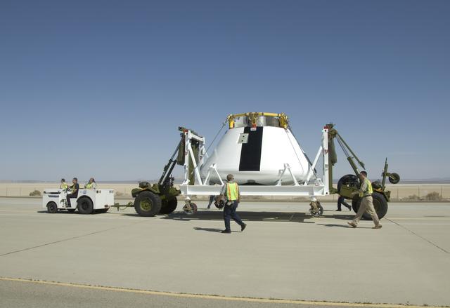 NASA image: NASA Dryden Flight Research Center personnel accompany NASA's first Orion full-scale abort flight test crew module as it heads to its new home.