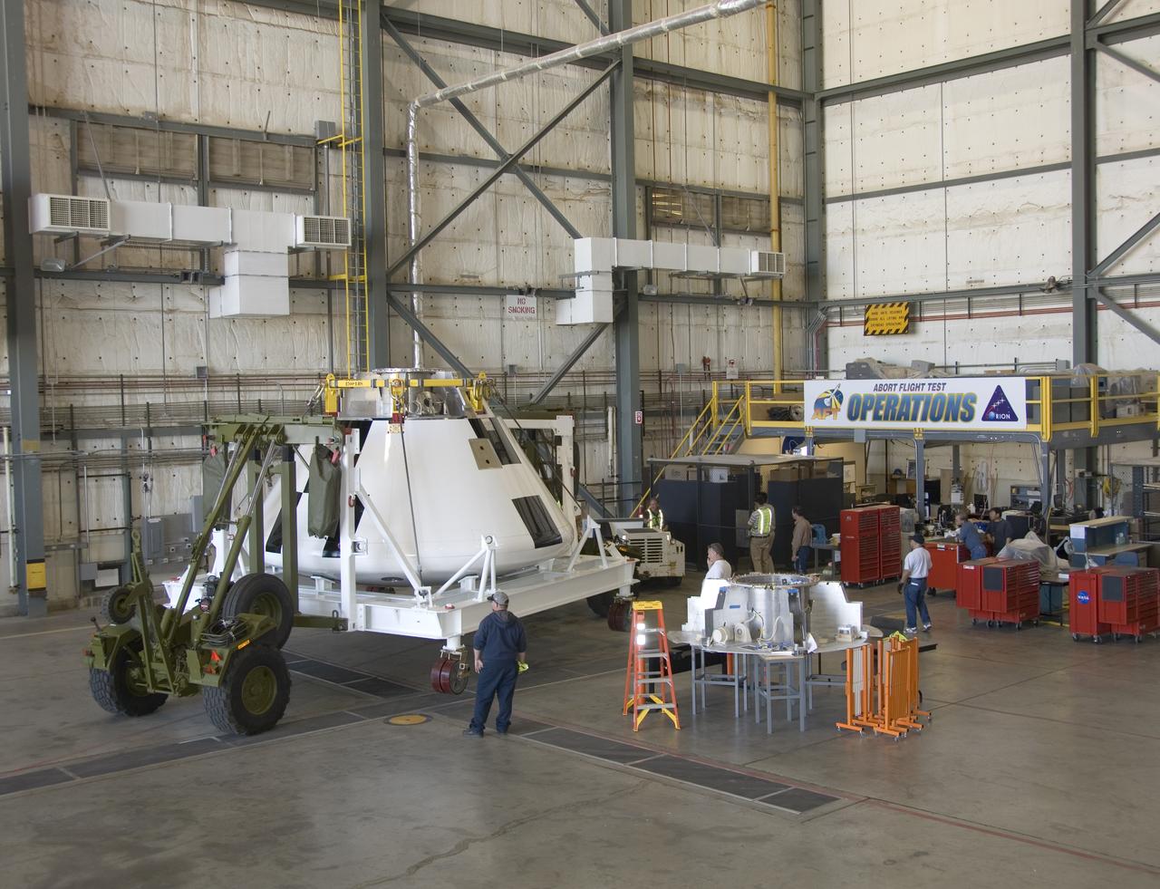 A full-scale flight-test mockup of the Constellation program's Orion crew vehicle arrived at NASA's Dryden Flight Research Center in late March 2008 to undergo preparations for the first short-range flight test of the spacecraft's astronaut escape system later that year. Engineers and technicians at NASA's Langley Research Center fabricated the structure, which precisely represents the size, outer shape and mass characteristics of the Orion space capsule. The Orion crew module mockup was ferried to NASA Dryden on an Air Force C-17. After painting in the Edwards Air Force Base paint hangar, the conical capsule was taken to Dryden for installation of flight computers, instrumentation and other electronics prior to being sent to the U.S. Army's White Sands Missile Range in New Mexico for integration with the escape system and the first abort flight test in late 2008. The tests were designed to ensure a safe, reliable method of escape for astronauts in case of an emergency.