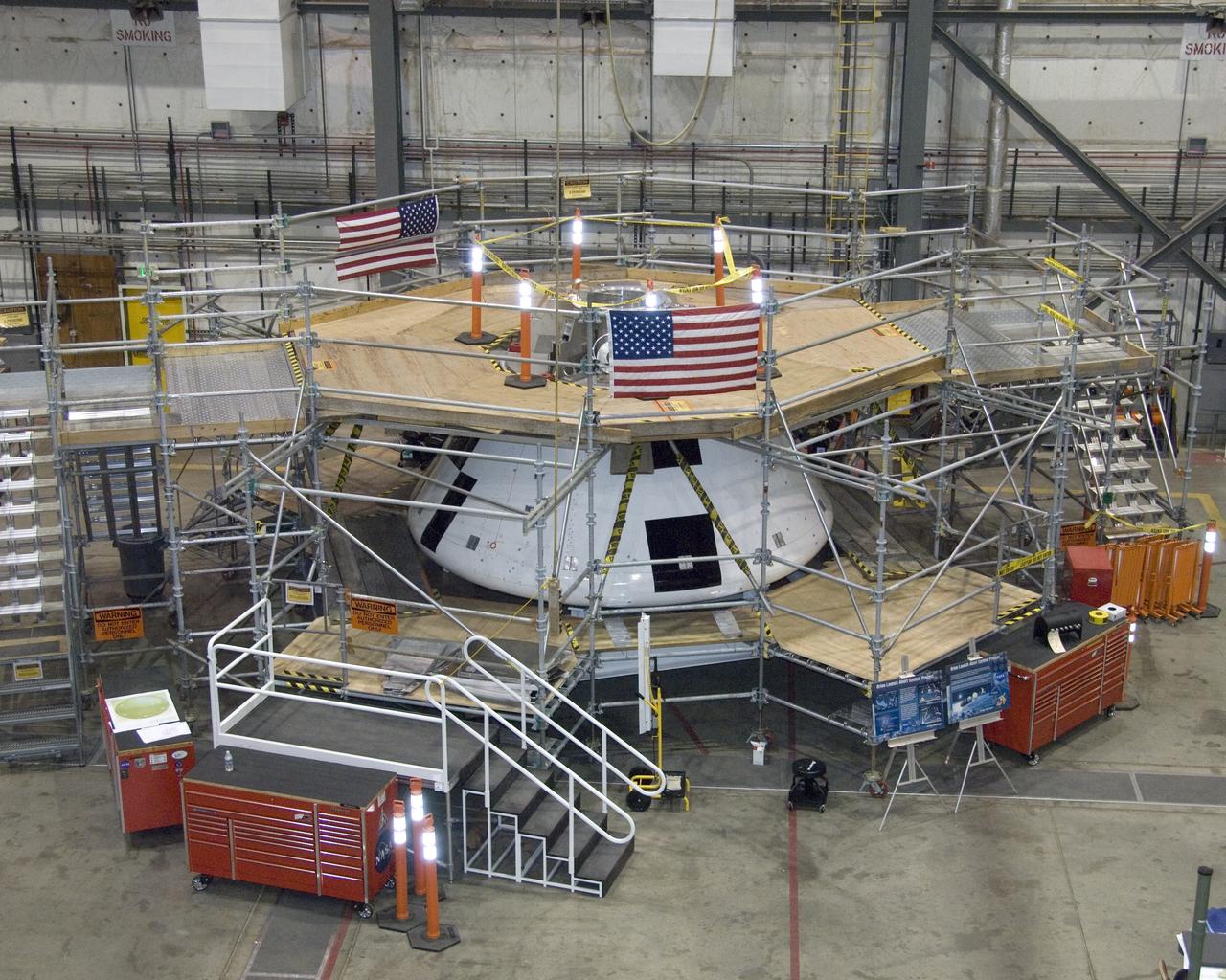 Surrounded by work platforms, NASA's first full-scale Orion abort flight test (AFT) crew module (center) is undergoing preparations at the NASA Dryden Flight Research Center in California for the first flight test of Orion's launch abort system.