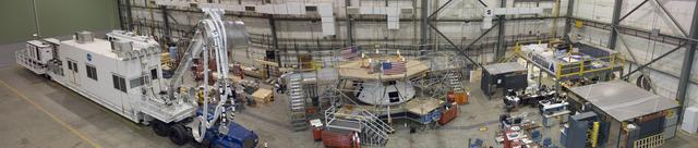Surrounded by work platforms, the full-scale Orion AFT crew module (center) is undergoing preparations for the first flight test of Orion's launch abort system.