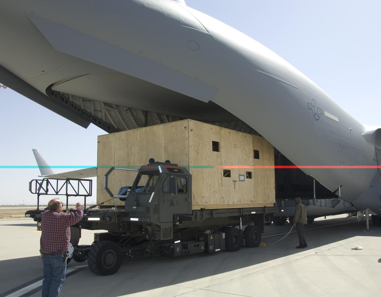 Technicians at NASA's Dryden Aircraft Operations Facility in Palmdale, Calif., loaded the German-built primary mirror assembly of the Stratospheric Observatory for Infrared Astronomy, or SOFIA, onto an Air Force C-17 for shipment to NASA's Ames Research Center on May 1, 2008. In preparation for the final finish coating of the mirror, the more than two-ton mirror assembly had been removed from its cavity in the rear fuselage of the highly modified SOFIA Boeing 747SP two weeks earlier. After arrival at NASA Ames at Moffett Field near Mountain View, Calif., the mirror would receive its aluminized finish coating before being re-installed in the SOFIA aircraft.