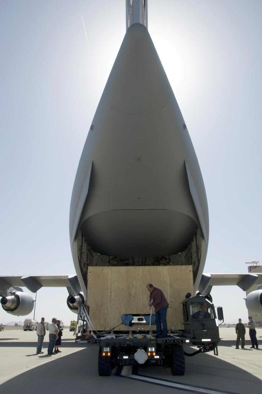 Technicians at NASA's Dryden Aircraft Operations Facility in Palmdale, Calif., loaded the German-built primary mirror assembly of the Stratospheric Observatory for Infrared Astronomy, or SOFIA, onto an Air Force C-17 for shipment to NASA's Ames Research Center on May 1, 2008. In preparation for the final finish coating of the mirror, the more than two-ton mirror assembly had been removed from its cavity in the rear fuselage of the highly modified SOFIA Boeing 747SP two weeks earlier. After arrival at NASA Ames at Moffett Field near Mountain View, Calif., the mirror would receive its aluminized finish coating before being re-installed in the SOFIA aircraft.