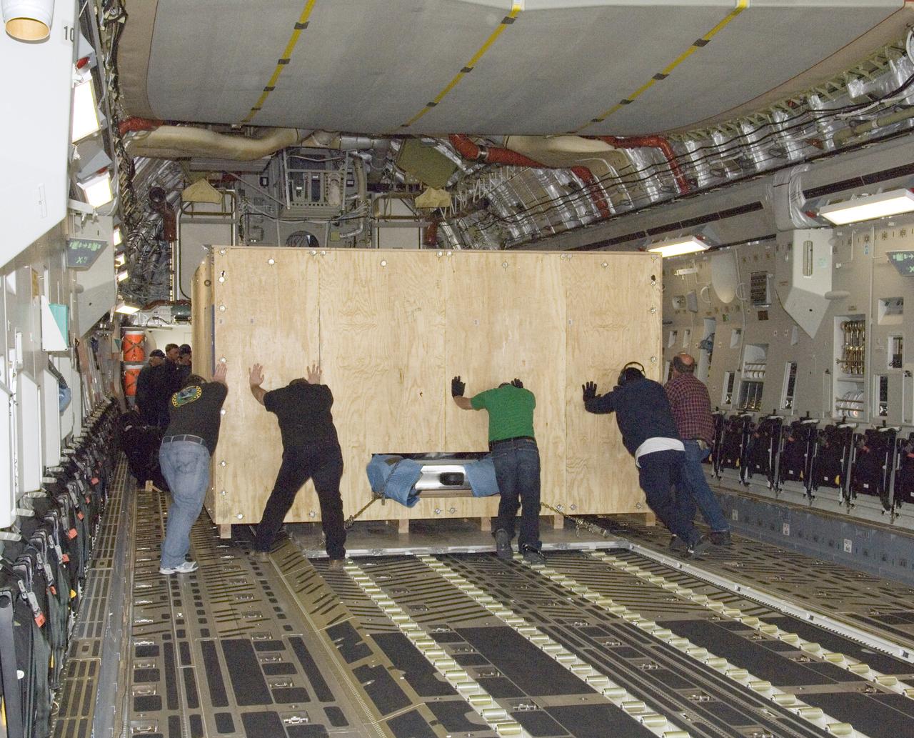 Technicians at NASA's Dryden Aircraft Operations Facility in Palmdale, Calif., loaded the German-built primary mirror assembly of the Stratospheric Observatory for Infrared Astronomy, or SOFIA, onto an Air Force C-17 for shipment to NASA's Ames Research Center on May 1, 2008. In preparation for the final finish coating of the mirror, the more than two-ton mirror assembly had been removed from its cavity in the rear fuselage of the highly modified SOFIA Boeing 747SP two weeks earlier. After arrival at NASA Ames at Moffett Field near Mountain View, Calif., the mirror would receive its aluminized finish coating before being re-installed in the SOFIA aircraft.