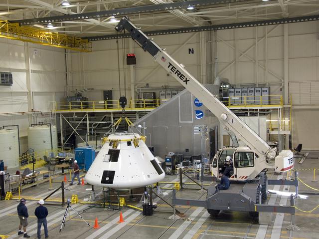 NASA image: Under the watchful eyes of technicians, a crane positions the Orion PA-1 Abort Flight Test module for mass properties testing in NASA Dryden's Flight Loads Lab.