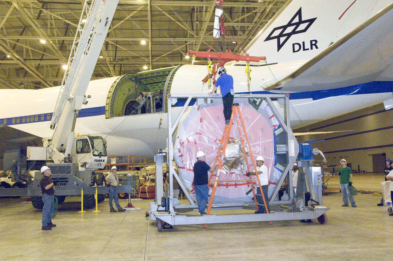 Engineers and technicians prepare SOFIA's German-built primary mirror assembly for reinstallation into NASA's 747SP airborne observatory.