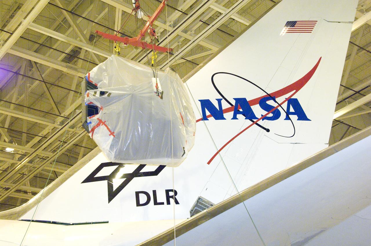 SOFIA's primary mirror assembly is lifted above wing level prior to its reinstallation in the telescope cavity of NASA's 747 airborne observatory Oct. 8, 2008.