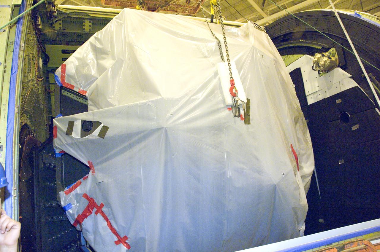 SOFIA's primary mirror is placed in the telescope cavity for reinstallation prior to telescope adjustments preparing SOFIA for first science.