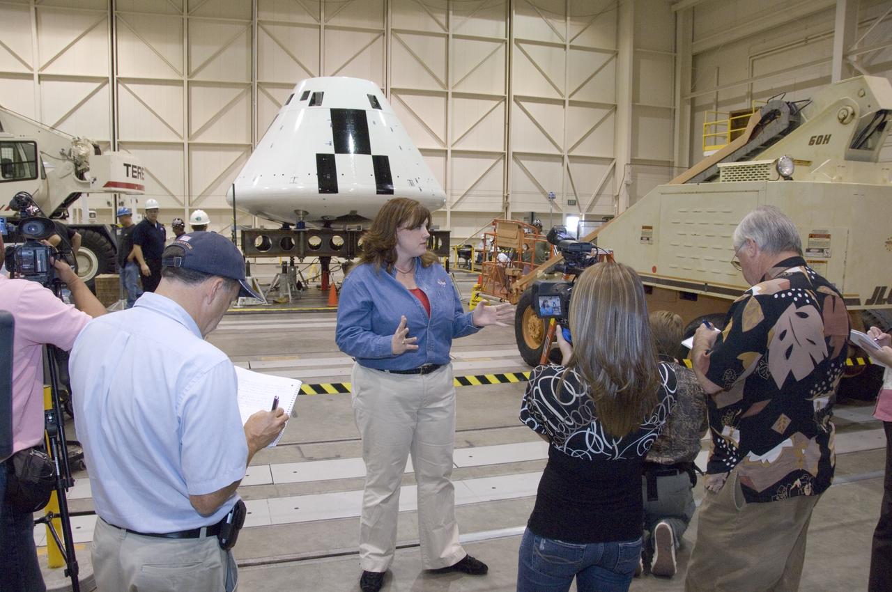 Cathy Bahm, Orion Abort Flight Test integration deputy project manager, briefs news media on the progress of testing in NASA Dryden's Flight Loads Laboratory.