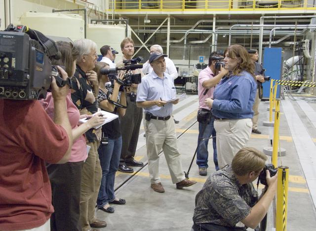 NASA image: Cathy Bahm, Orion Abort Flight Test integration deputy project manager, briefs news media on the progress of testing in NASA Dryden's Flight Loads Laboratory.