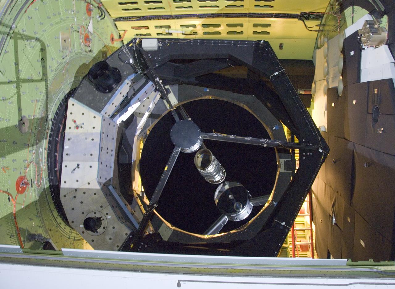 The 2.5-meter infrared telescope peers out from its cavity in the SOFIA airborne observatory during nighttime line operations testing at Palmdale, Calif.