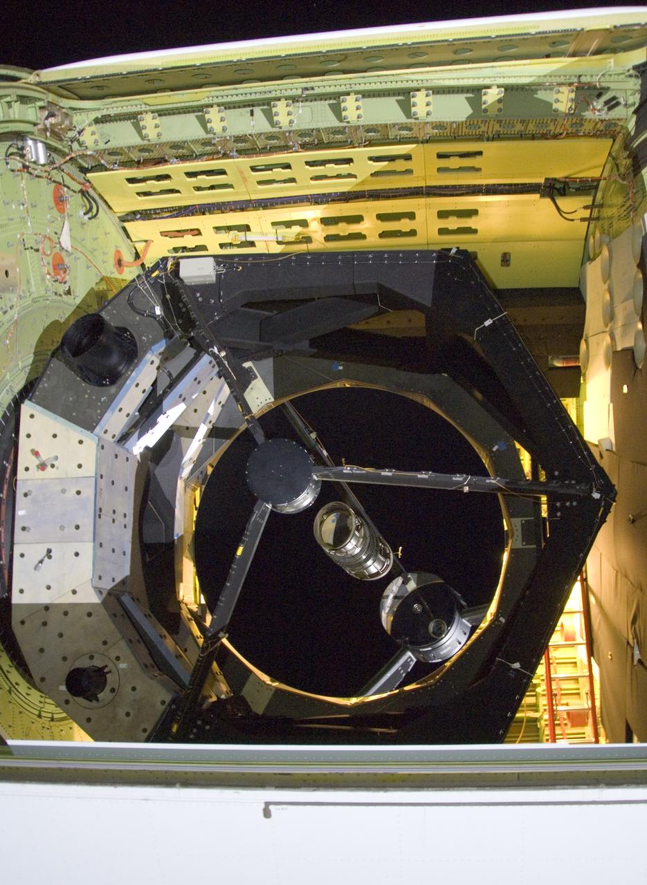 he SOFIA airborne observatory's 2.5-meter infrared telescope peers out from its cavity in the SOFIA rear fuselage during nighttime line operations testing.