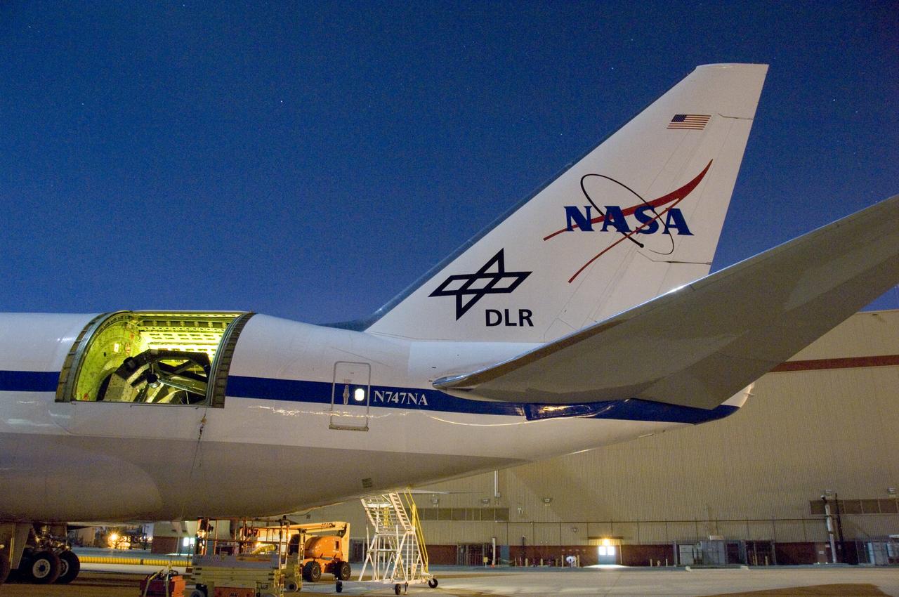 The SOFIA airborne observatory's 2.5-meter infrared telescope peers out from its cavity in the SOFIA rear fuselage during nighttime line operations testing.