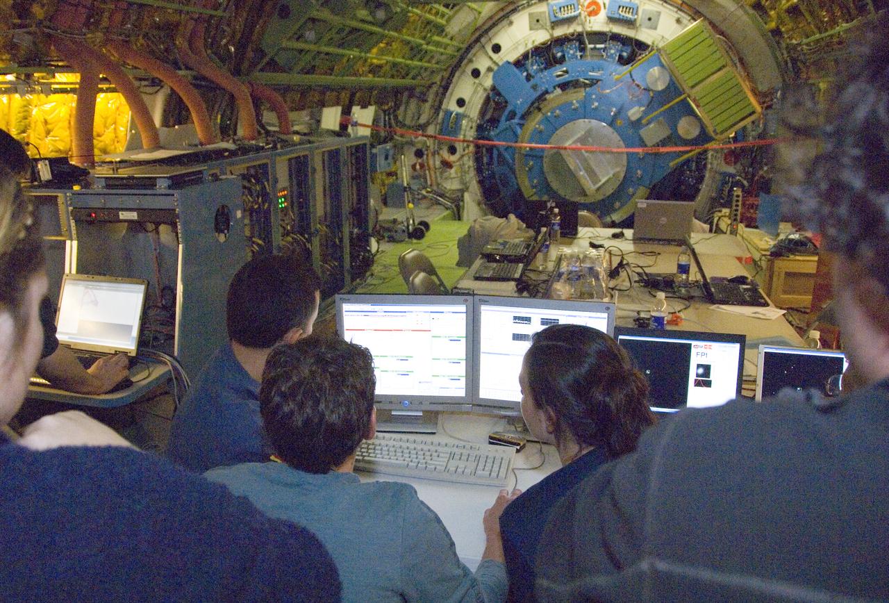 Scientists carefully examine data being received during nighttime line operations testing of the SOFIA airborne observatory's 2.5-meter infrared telescope.