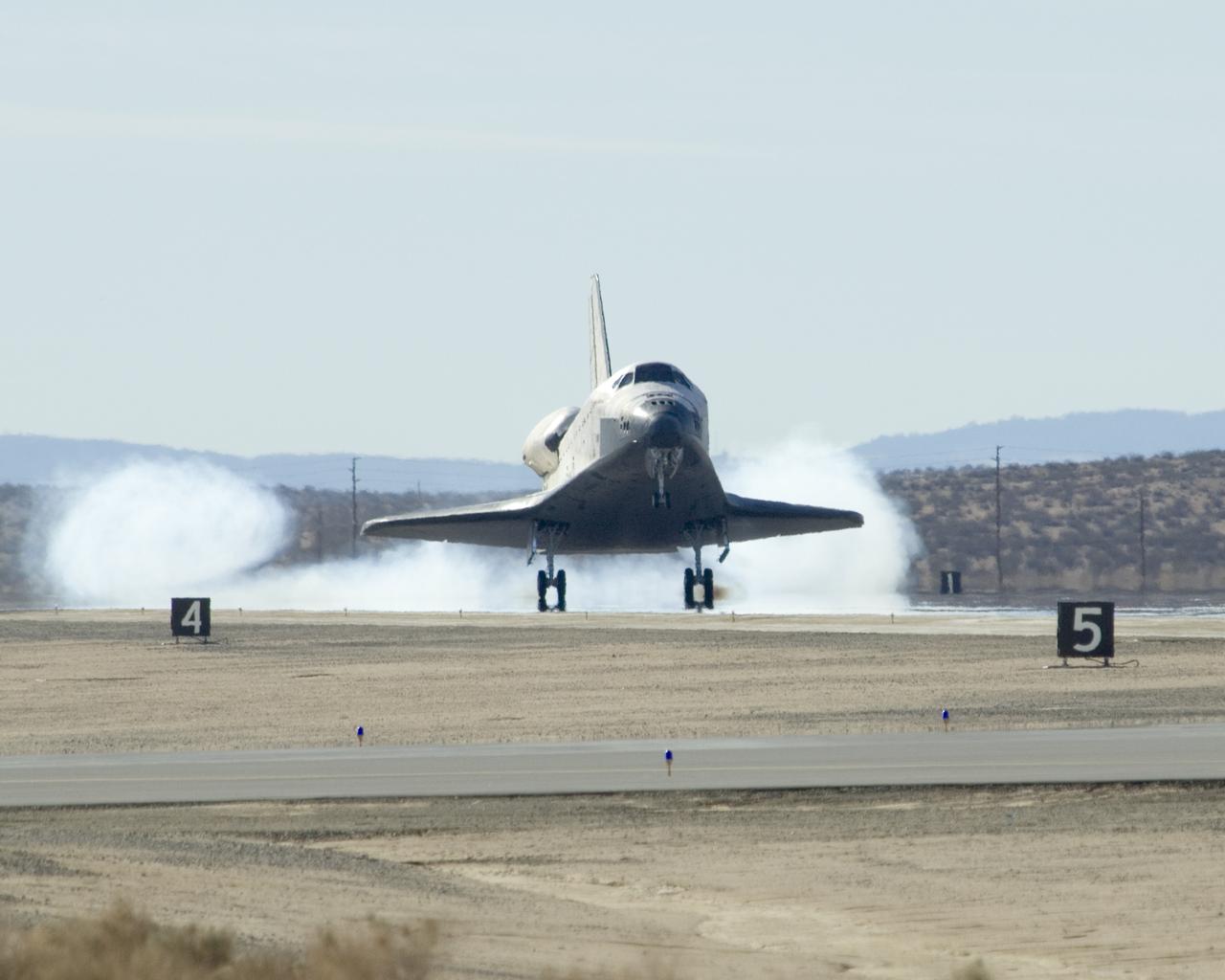 Smoke swirls as Space Shuttle Endeavour's tires strike the runway at Edwards Air Force Base Nov. 30 to conclude mission STS-126 to the International Space Station.