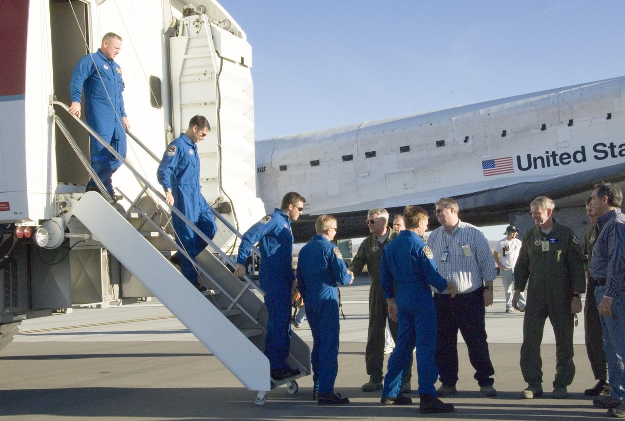 Air Force and NASA officials greet the STS-126 crew as they exit the Crew Transport Vehicle after landing the shuttle Endeavour at Edwards Air Force Base.