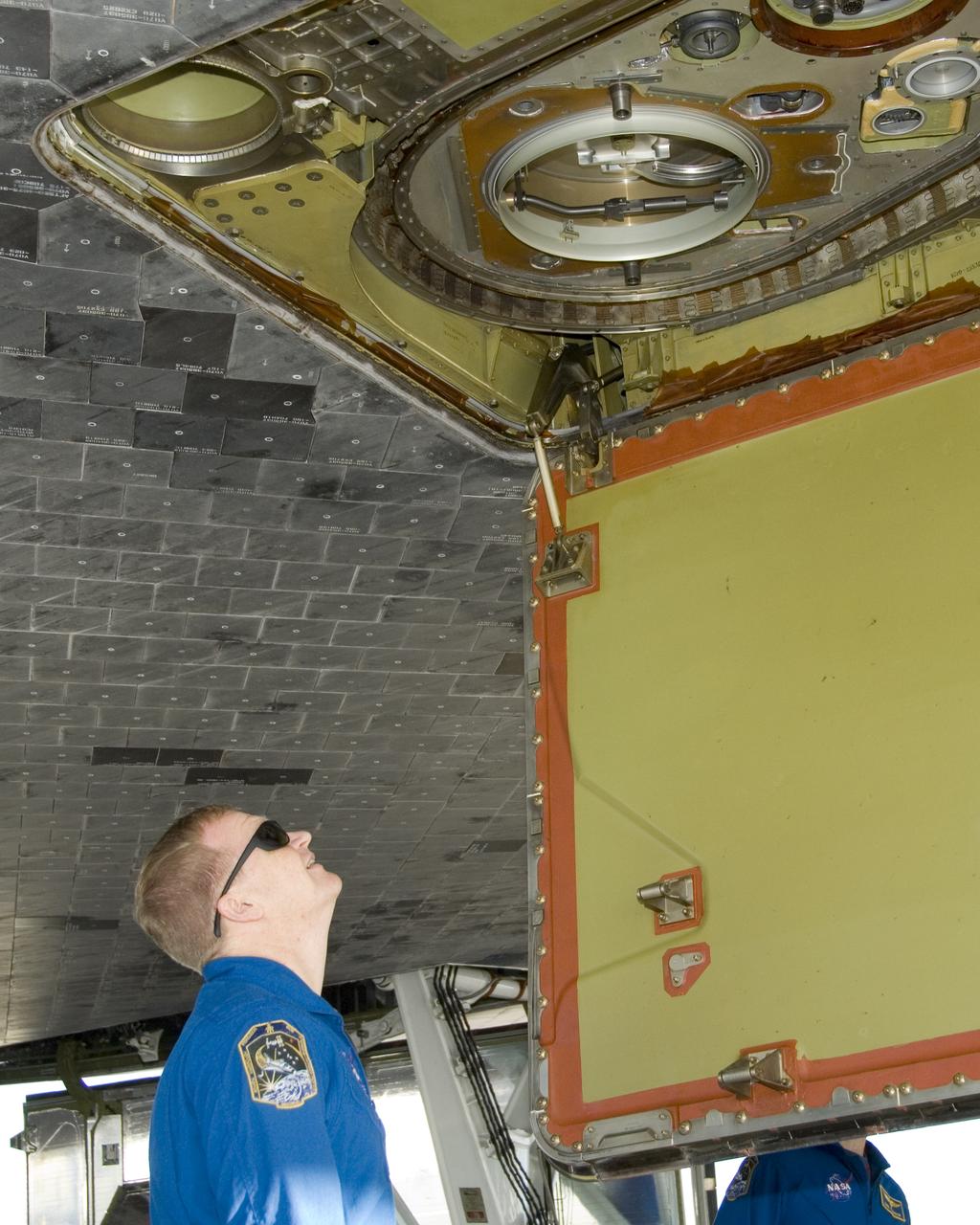 STS-126 pilot Eric Boe inspects the liquid oxygen line connection on the belly of Space Shuttle Endeavour following landing at Edwards Air Force Base Sunday.