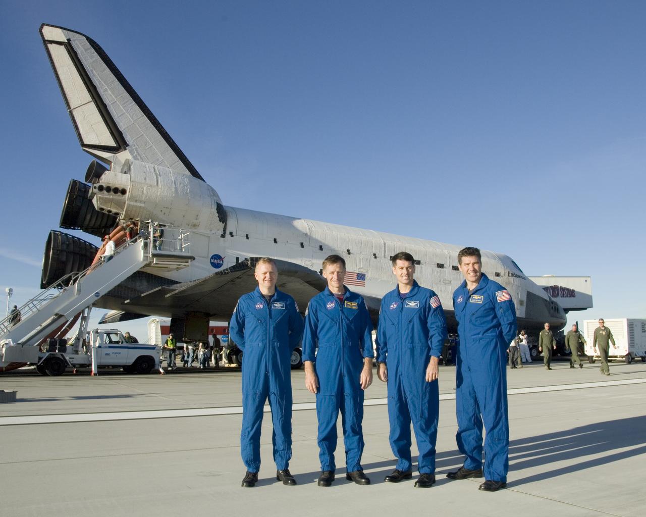 STS-126 crewmen Eric Boe, Chris Ferguson, Robert Kimbrough and Stephen Bowen pose in front of the Space Shuttle Endeavour following landing Nov. 30, 2008.