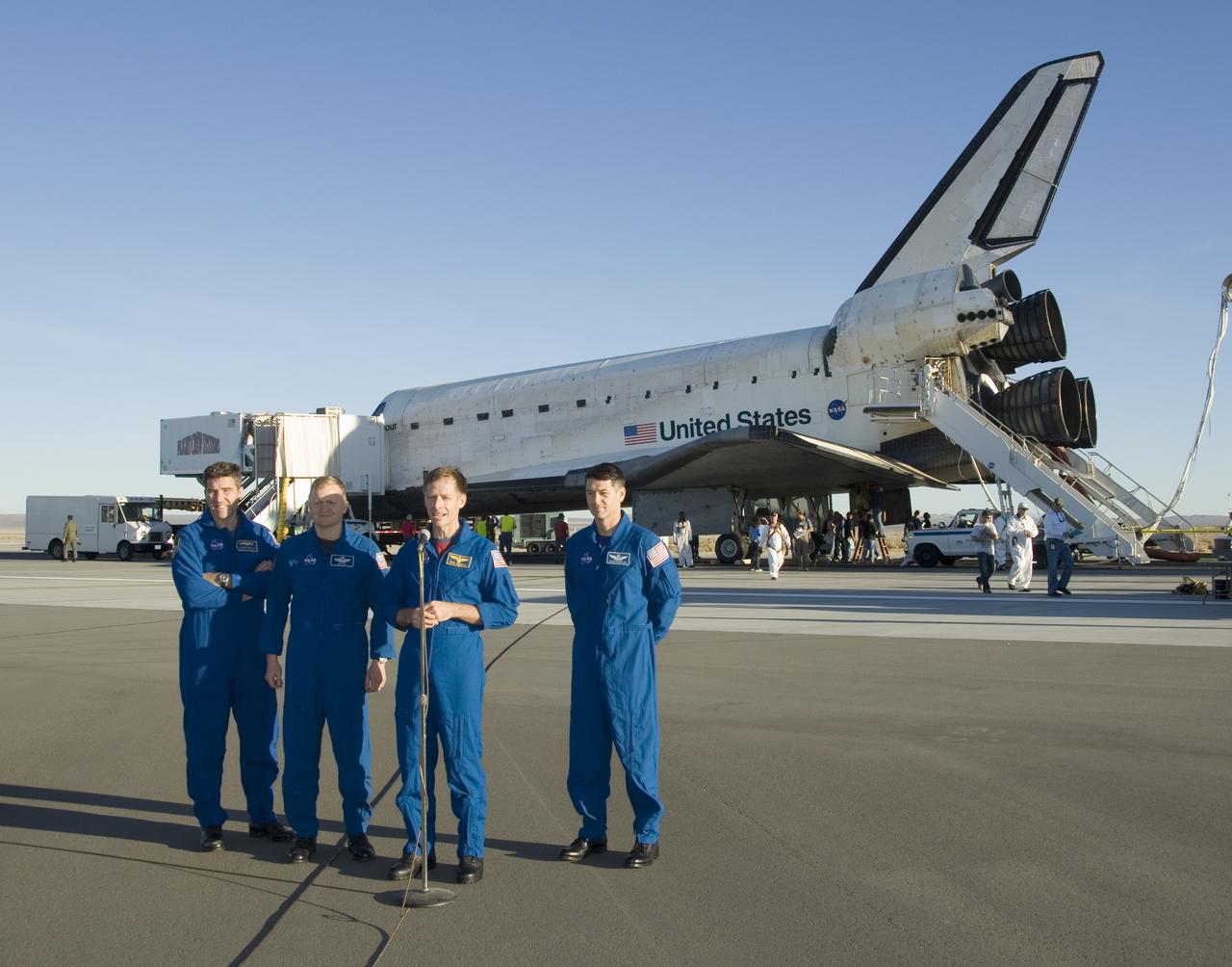 STS-126 commander Chris Ferguson, flanked by crewman Stephen Bowen, Eric Boe and Robert Kimbrough, offers comments on the mission after landing at Edwards AFB.
