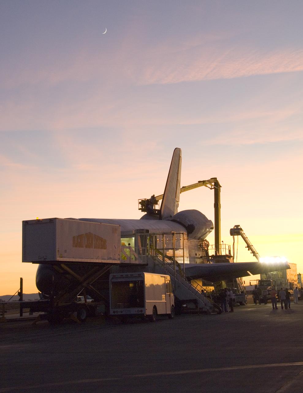 Its STS-126 mission over, Space Shuttle Endeavour is surrounded by recovery equipment before being towed off the Edwards Air Force Base runway.