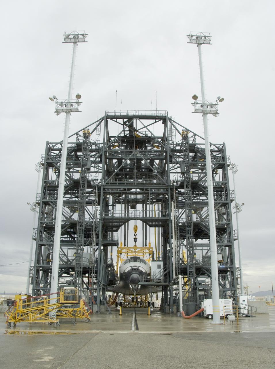 Under soggy skies on a Sunday morning, the Space Shuttle Endeavour is encased in the Mate-DeMate gantry during turnaround processing at NASA's Dryden Flight Research Center following its STS-126 landing at Edwards Air Force Base a week earlier.