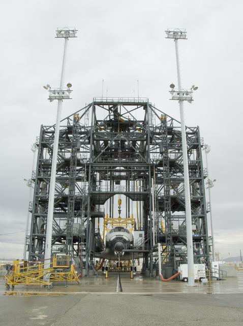 NASA image: Under soggy skies on a Sunday morning, the Space Shuttle Endeavour is encased in the Mate-DeMate gantry during turnaround processing at NASA DFRC