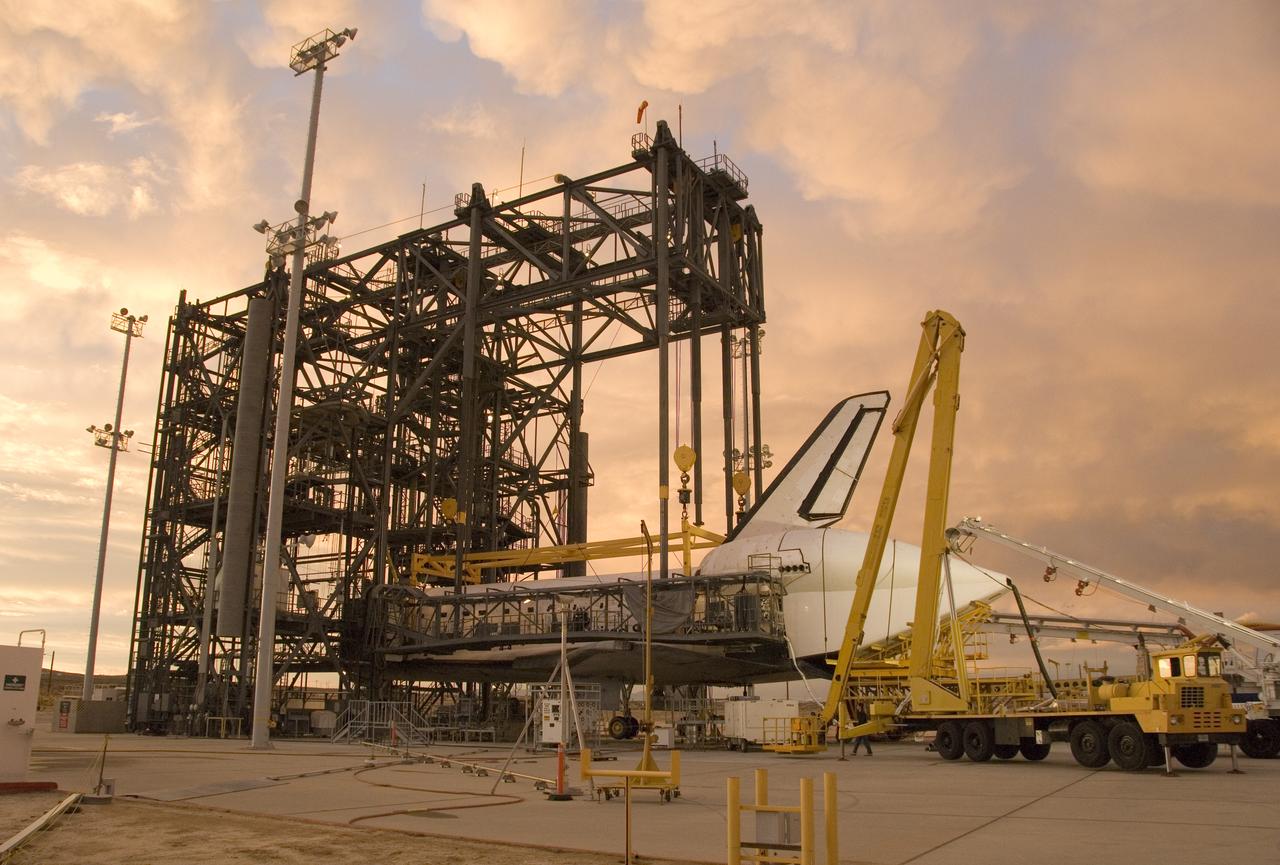 Puffy pink clouds form a canopy over the Space Shuttle Endeavour as processing continues in the Mate-Demate Device at NASA Dryden Flight Research Center in preparation for its ferry flight back to the Kennedy Space Center.