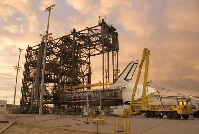 NASA image: Puffy pink clouds form a canopy over the Space Shuttle Endeavour as processing continues in the Mate-Demate Device at NASA's Dryden Flight Research Center