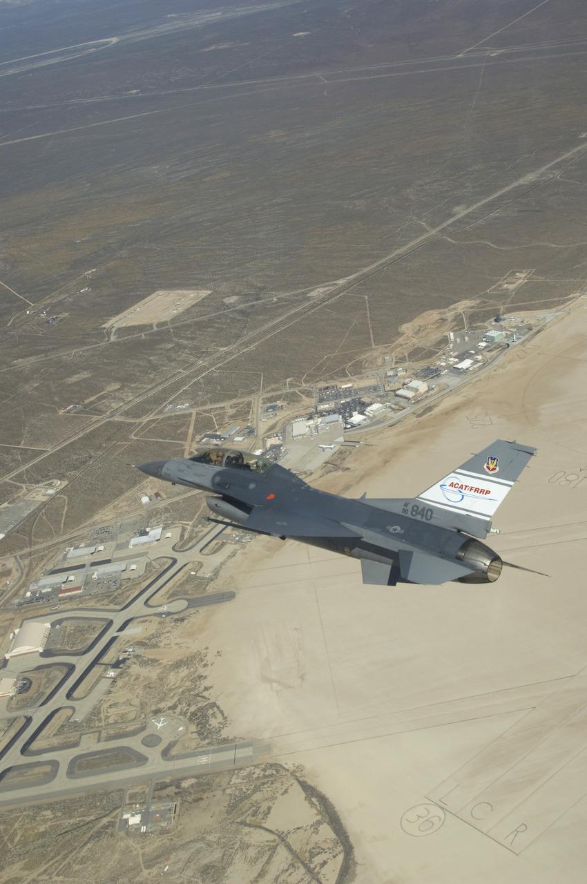 The U.S. Air Force's F-16D Automatic Collision Avoidance Technology (ACAT) aircraft banks over NASA's Dryden Flight Research Center during a March 2009 flight. NASA Dryden worked with the Air Force Research Laboratory in the ACAT Fighter Risk Reduction Project to develop collision avoidance technologies for fighter/attack aircraft that would reduce the risk of ground and mid-air collisions.