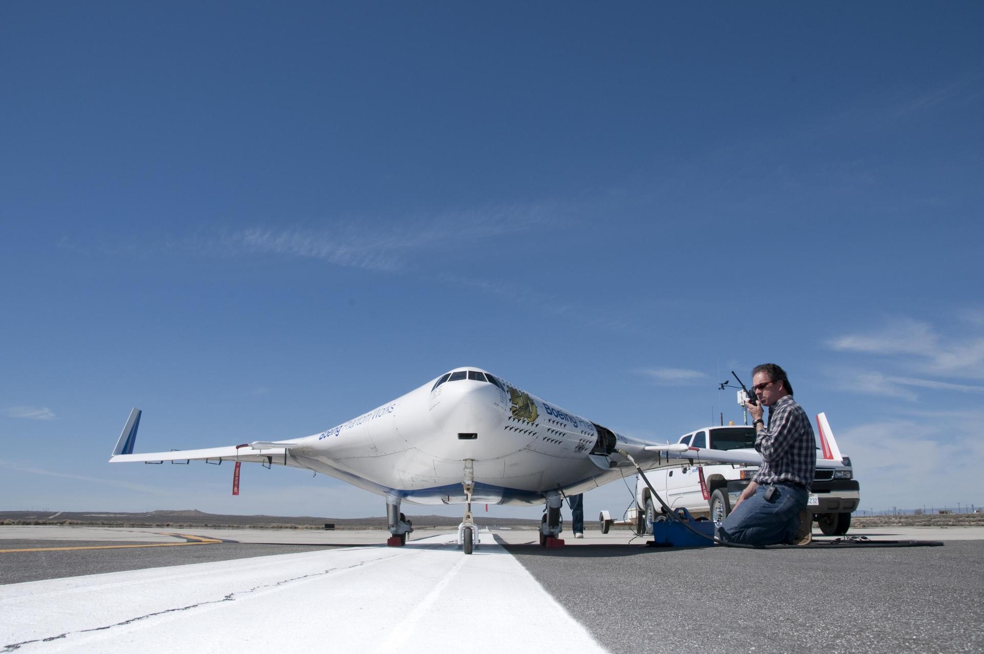 NASA engineer Gary Cosentino communicates with fellow X-48B flight team personnel in preparation for another flight.