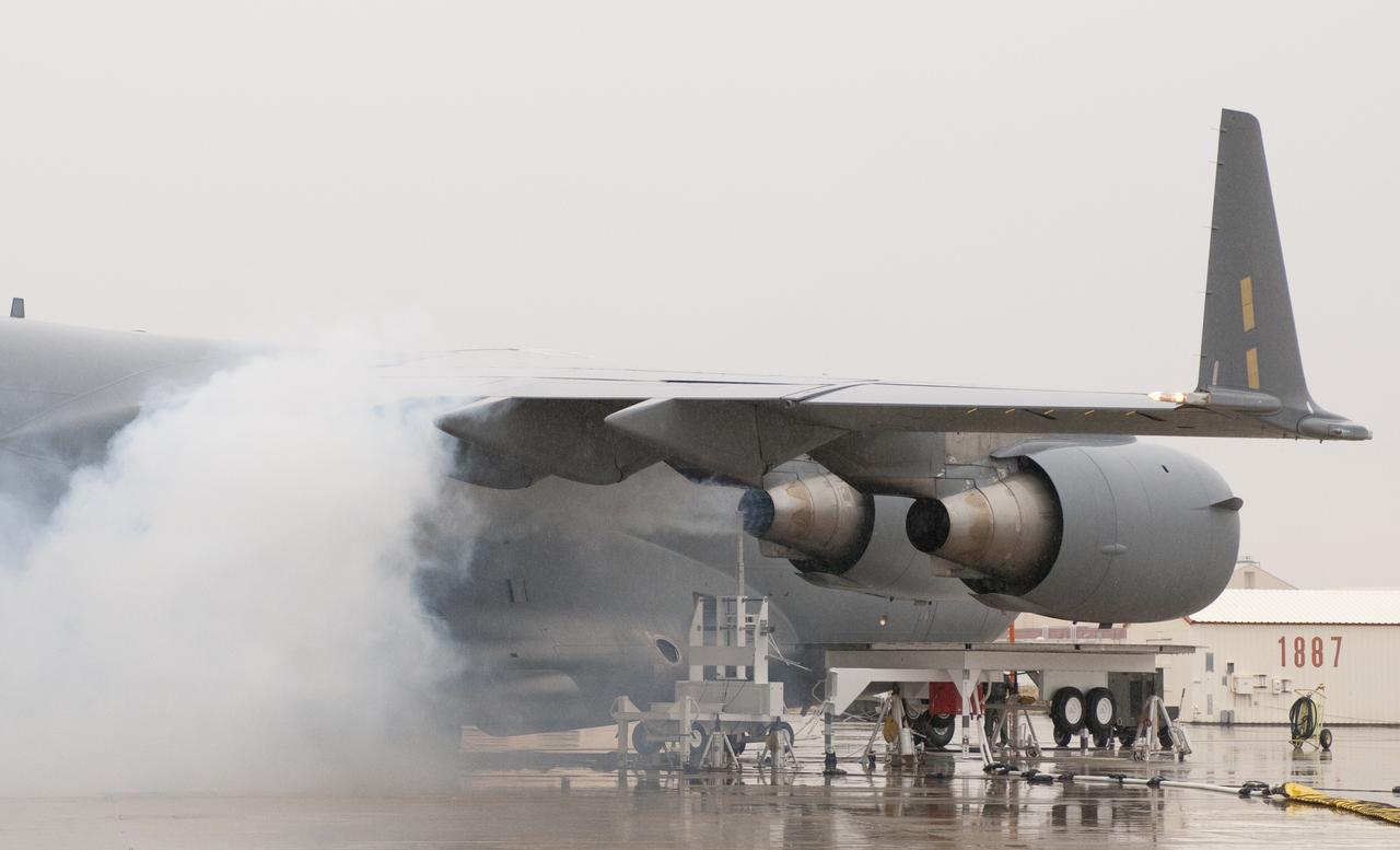 Oil smoke billows from the right inboard engine of the C-17 while a probe collects emissions data during 2011 VIPR engine health monitoring tests.