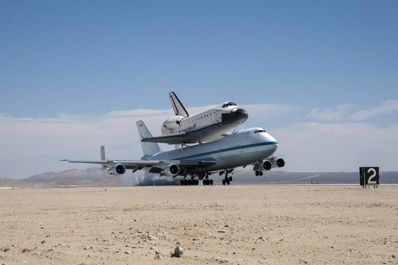 Space shuttle Endeavour and its host NASA 747 Shuttle Carrier Aircraft land at Edwards Air Force Base in California. It completed its third leg of a four-segment final ferry flight from NASA’s Kennedy Space Center in Florida to Los Angeles International Airport on Sept. 20, 2012. The landing was preceded by NASA’s Armstrong (then Dryden) Flight Research Center pilot Bill Brockett’s low-level flyby of the center and the Edwards flight line.
