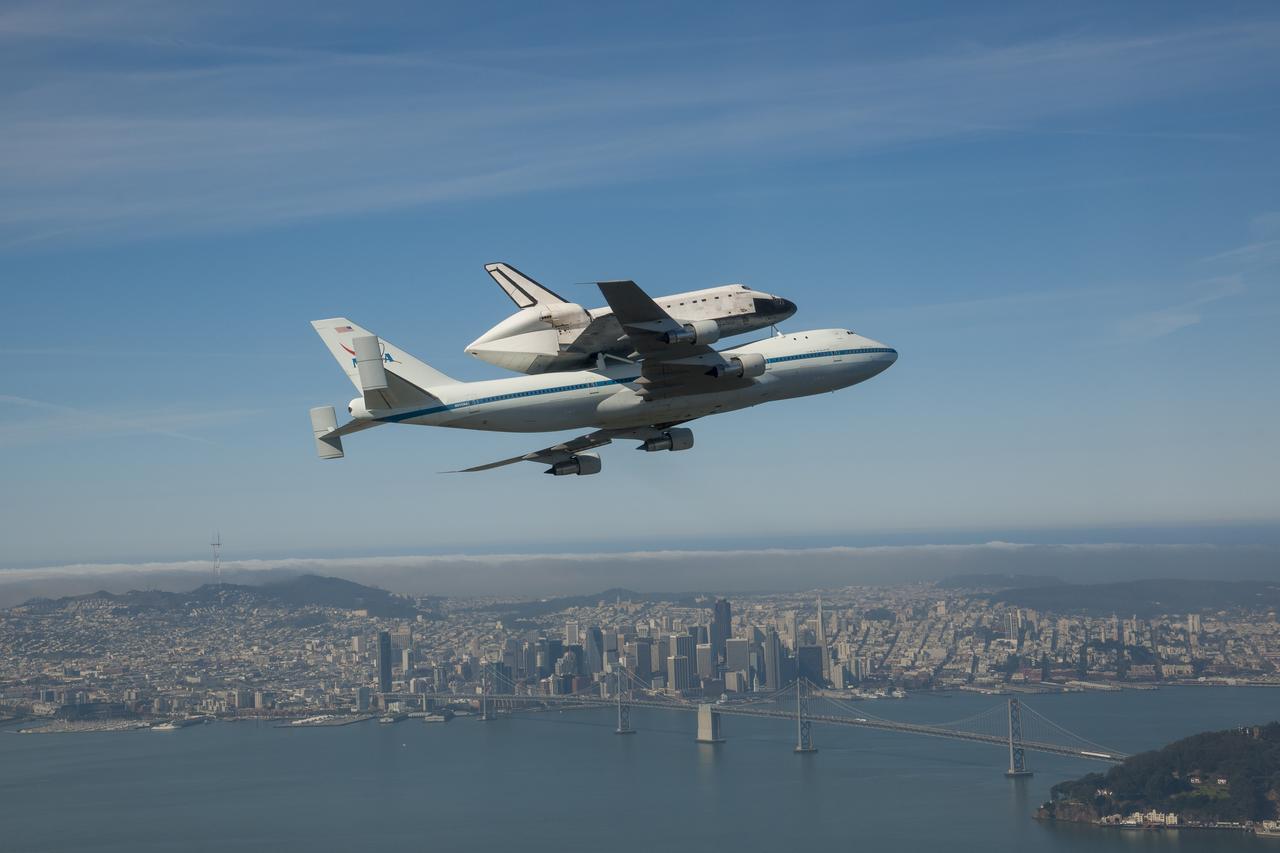 Space shuttle Endeavour and its host NASA 747 Shuttle Carrier Aircraft fly by the Bay Bridge in 2012 on its way to the Los Angeles International Airport and an overland journey to the California Science Center. The final leg of Endeavour’s flight from NASA’s Kennedy Space Center, Florida, offered many people an opportunity to witness the historic flight.