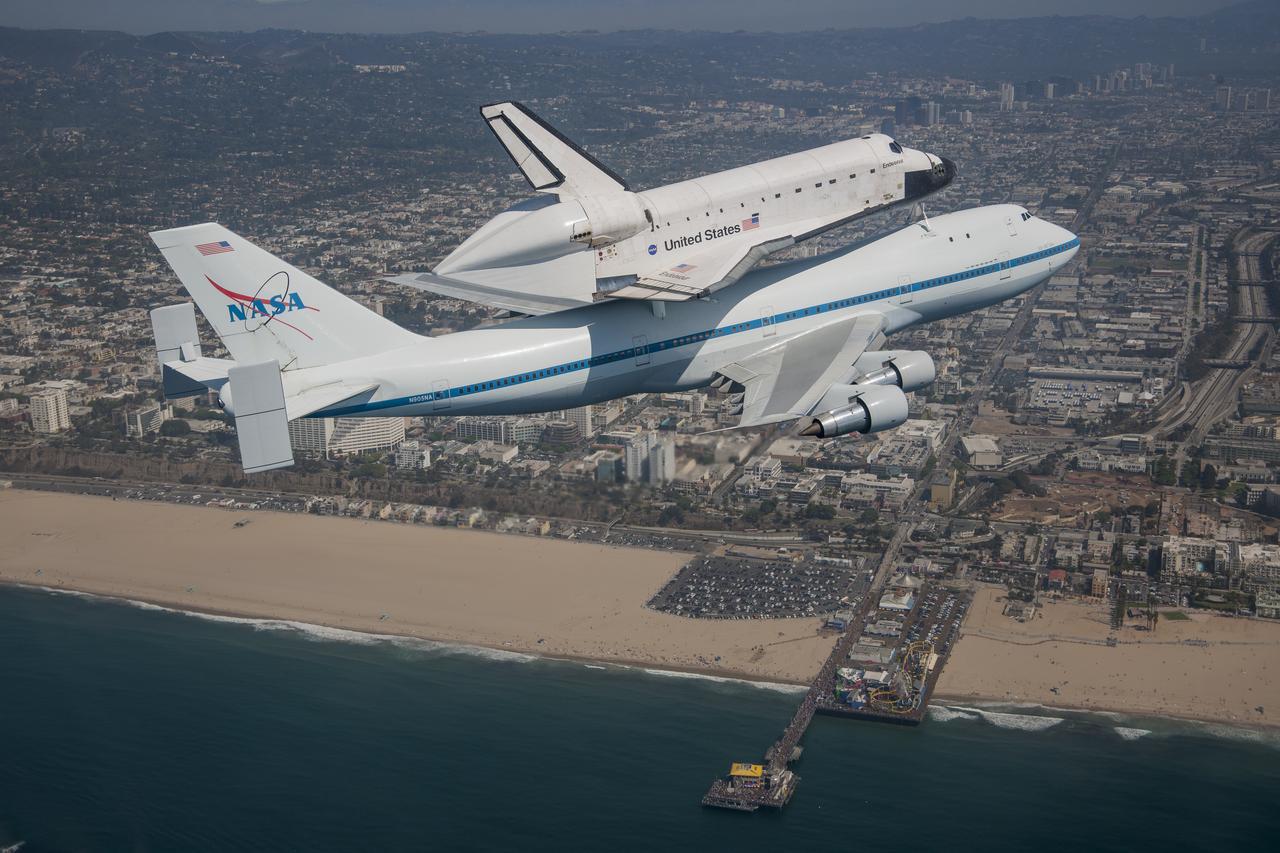 Space shuttle Endeavour and its host NASA 747 Shuttle Carrier Aircraft fly over the Santa Monica Pier in 2012 on its way to the Los Angeles International Airport, and an overland journey to the California Science Center. Californians gazed at the morning sky Sept. 21 looking for Endeavour over their community. The final leg of Endeavourâ€™s flight from NASAâ€™s Kennedy Space Center, Florida, offered many people an opportunity to witness the historic flight.
