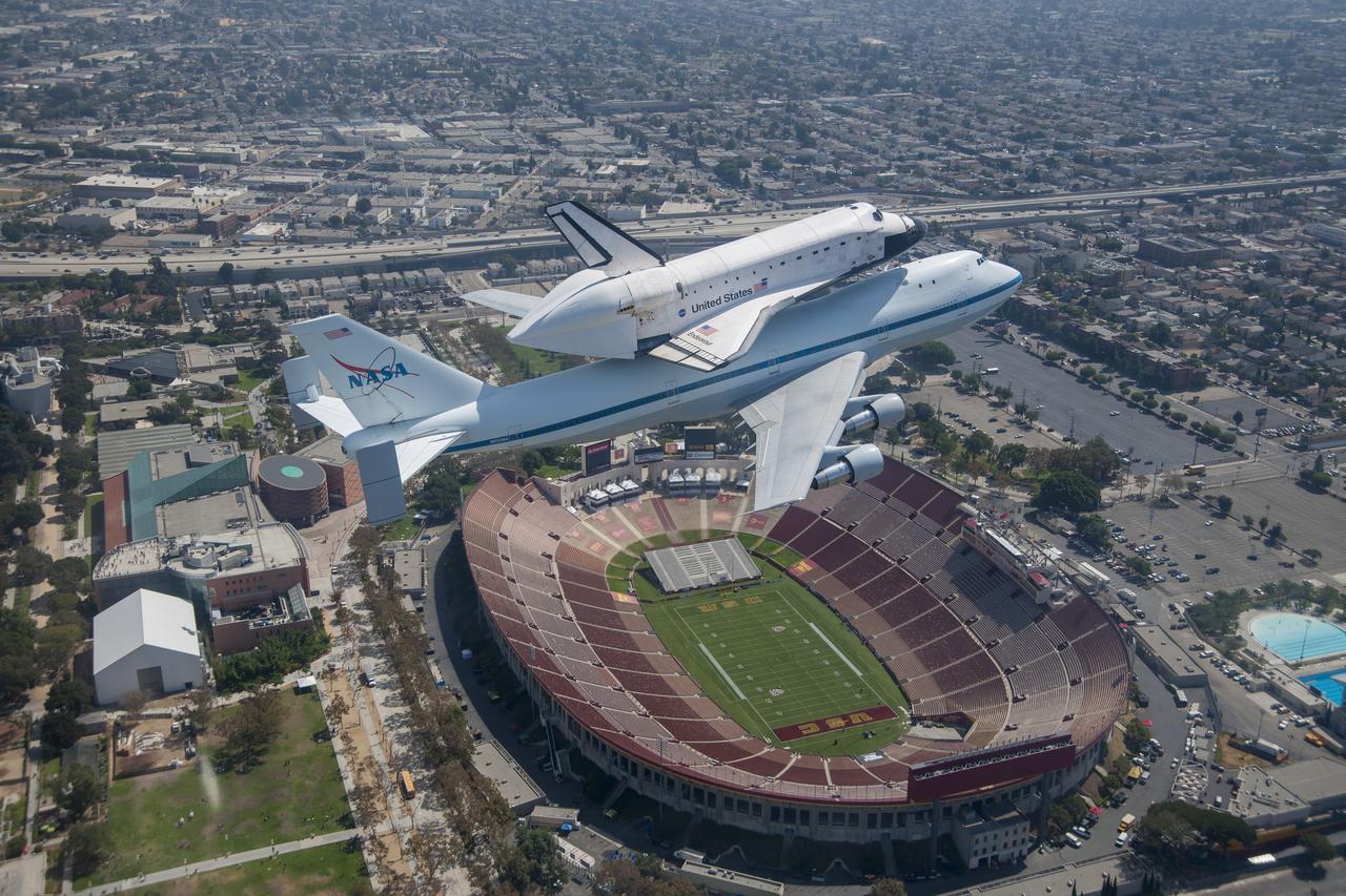 Space shuttle Endeavour and its host NASA 747 Shuttle Carrier Aircraft fly over the Los Angeles Coliseum in 2012 on its way to the Los Angeles International Airport, and an overland journey to the California Science Center. Californians looked up at the morning sky Sept. 21 looking for Endeavour over their community. The final leg of Endeavour’s flight from NASA’s Kennedy Space Center, Florida, offered many people an opportunity to witness the historic flight.
