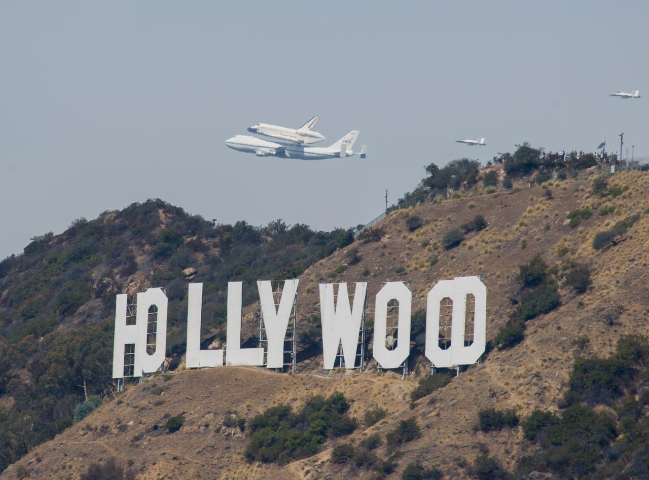 Space shuttle Endeavour and its host NASA 747 Shuttle Carrier Aircraft fly over the Hollywood sign in 2012 on its way to the Los Angeles International Airport, and an overland journey to the California Science Center. Californians looked up at the morning sky Sept. 21 looking to see Endeavour fly over their community. The final leg of Endeavour’s flight from NASA’s Kennedy Space Center, Florida, offered many people an opportunity to witness the historic flight.