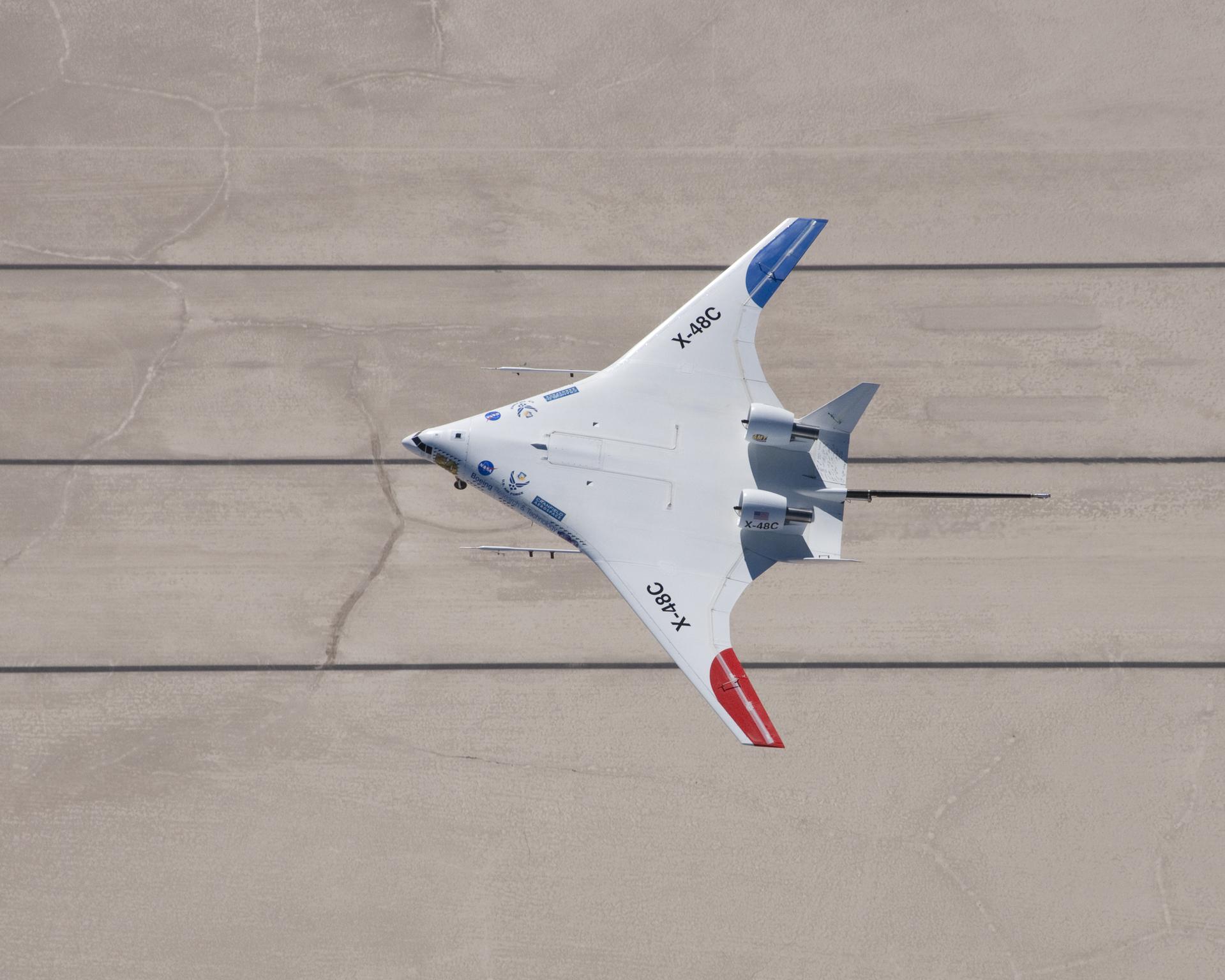 NASA X-48C Hybrid Wing Body aircraft flew over one of the runways laid out on Rogers Dry Lake at Edwards Air Force Base, CA, during a test flight from NASA's Dryden Flight Research Center on Feb. 28, 2013.