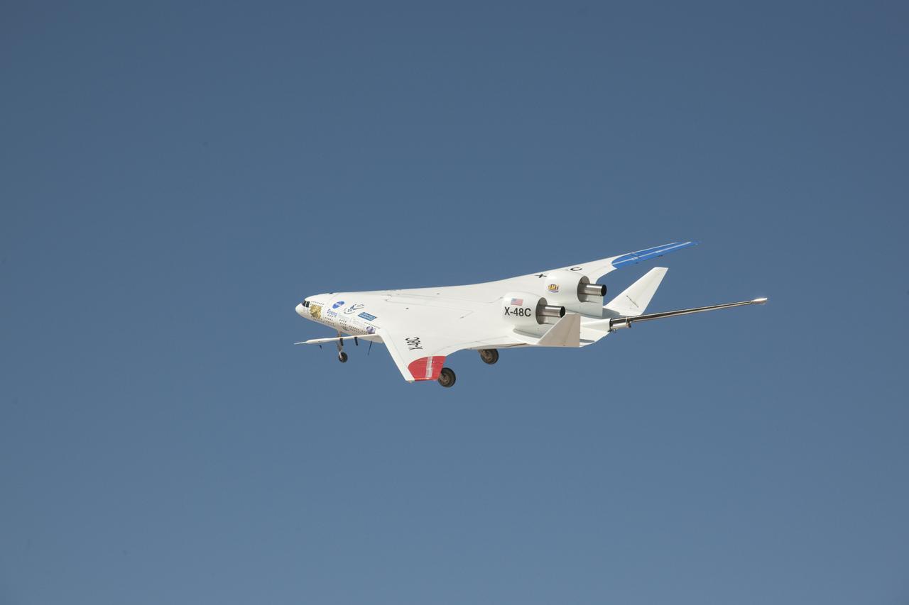 A deep blue sky was a backdrop for the NASA-Boeing X-48C Hybrid Wing Body aircraft as it flew over Edwards AFB on Feb. 28, 2013, during a test flight from NASA's Dryden Flight Research Center, Edwards, CA.