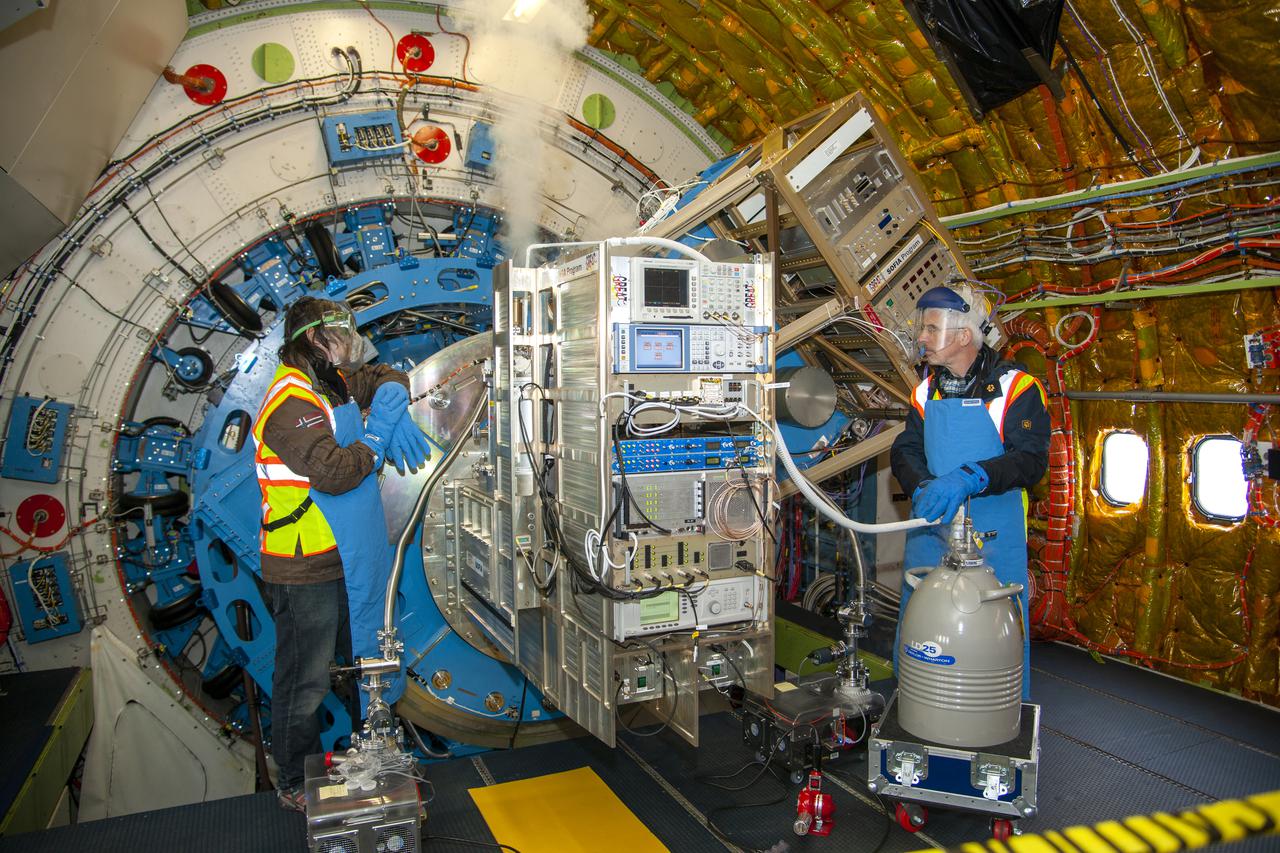 Technicians introduce liquid nitrogen to an instrument linked to SOFIA’s telescope. Detection of infrared wavelengths is greatly enhanced by removing as much heat from the telescope as possible.