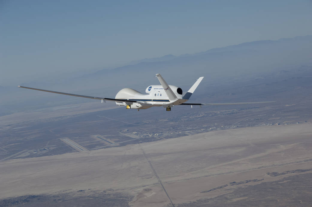 NASA's Global Hawk 872 soared over Rogers Dry Lake at Edwards Air Force Base, CA, during an instrument checkout flight for the 2014 ATTREX mission over the western Pacific Ocean.