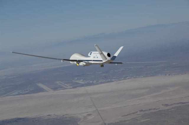 NASA's Global Hawk 872 soared over Rogers Dry Lake at Edwards Air Force Base, CA, during an instrument checkout flight for the 2014 ATTREX mission over the western Pacific Ocean. The aircraft carried 13 science instruments to measure moisture and chemical composition of the stratosphere during the campaign.