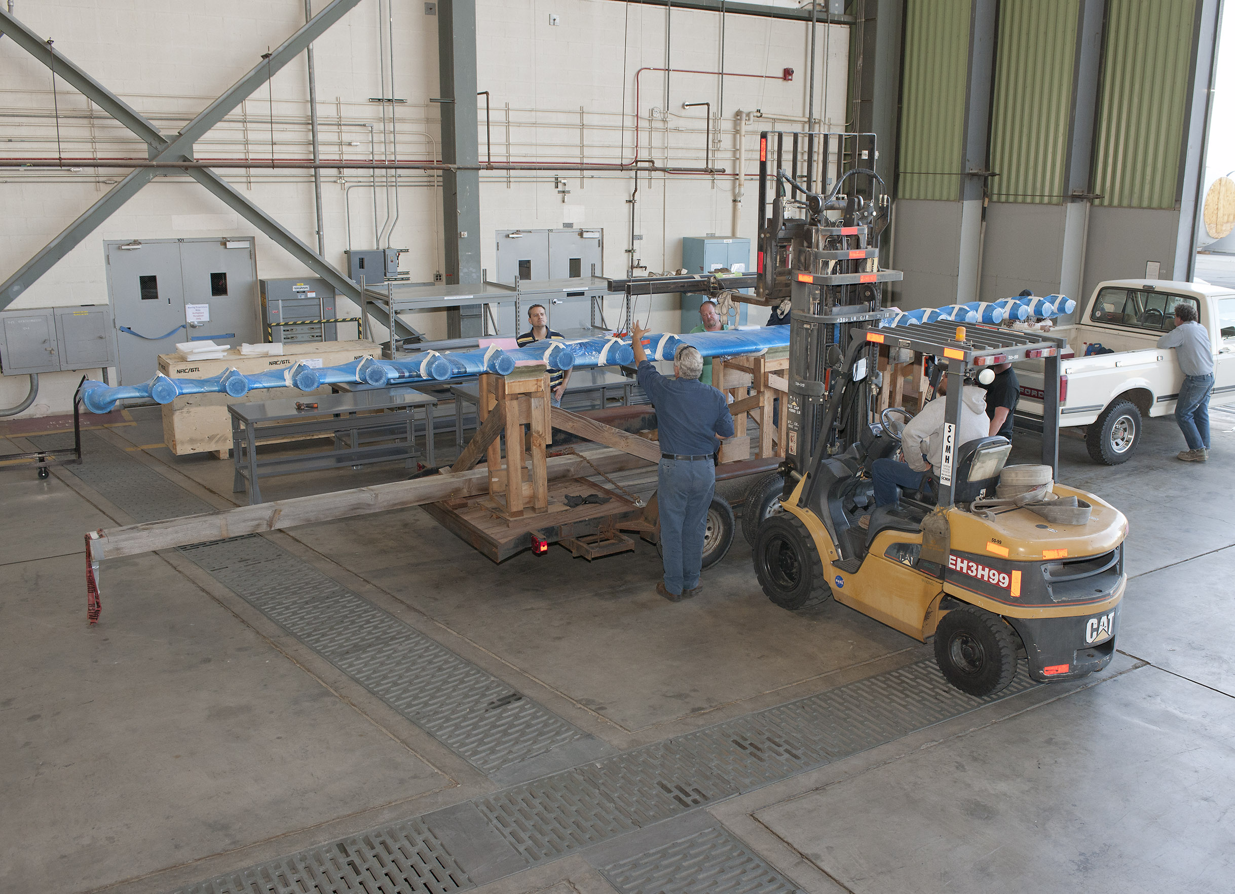 Technicians unload the LEAPTech experimental wing upon its arrival at NASA Armstrong Flight Research Center. Ground testing will begin after the wing is mounted on a specially modified truck.