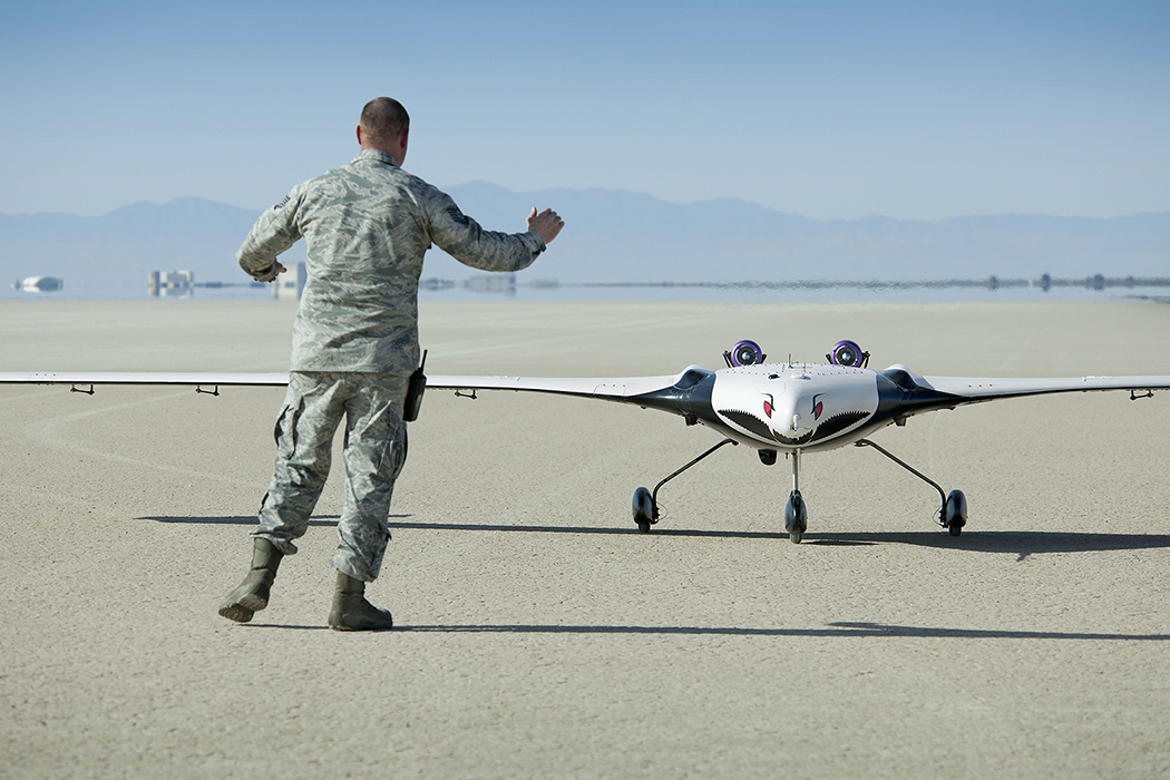 The X-56A Multi-Utility Technology Testbed (MUTT) is greeted on an Edwards Air Force Base runway by a U.S. Air Force Research Laboratory (AFRL) team member.