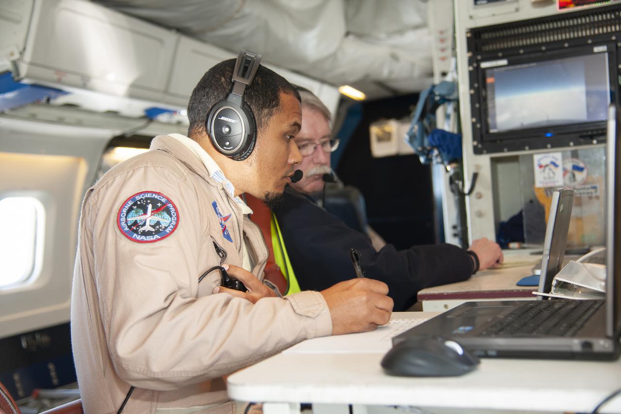 Matt Berry, left, and Chris Jennison examine incoming data on NASA’s DC-8 airborne science aircraft. The 62-year-old ex-airliner is one of seven DC-8s still flying.