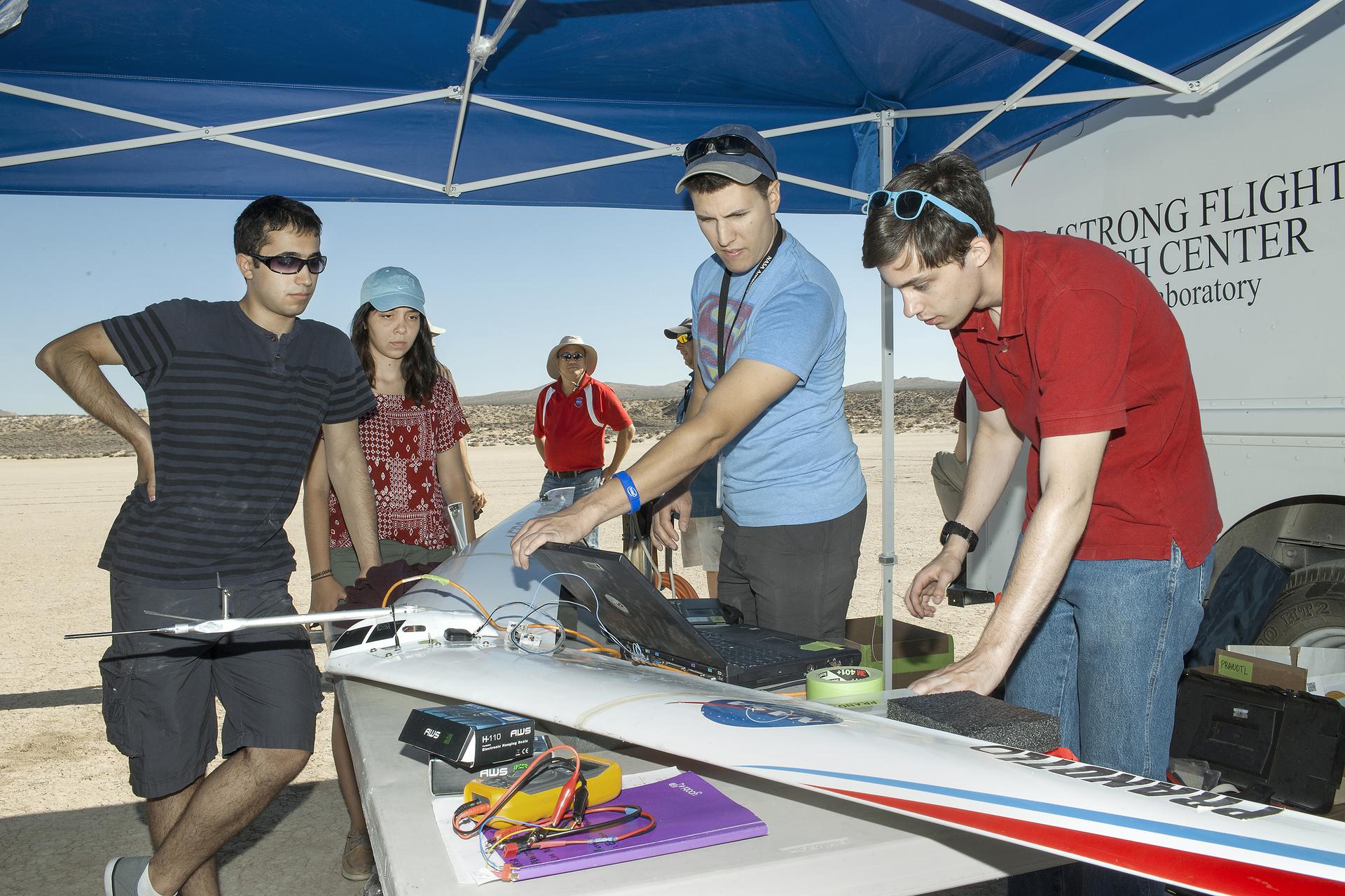Jonathan Zur, from left, Alexandra Ocasio, Derek Abramson, Red Jensen, Etan Halberg and Keenan Albee wait for data to download from a Prandtl-d flight